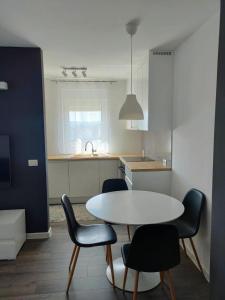 a kitchen with a table and chairs in a room at Apartment Maria in Tomislavgrad