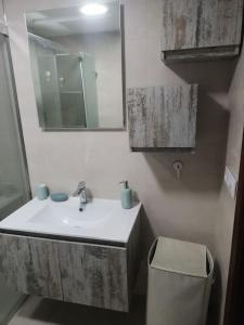 a bathroom with a sink and a mirror and a toilet at Piso en la Costilla-Rota in Rota +15 photos