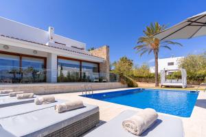 a villa with a swimming pool and a house at Beautiful Villa Bohemia Ibiza in Sant Josep de Sa Talaia