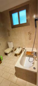 a bathroom with a tub and a toilet and a sink at Le Caravelle in Rapallo +16 photos