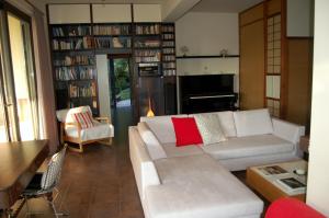 a living room with a white couch and book shelves at Serene retreat in Rhodes Town