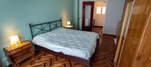 a bedroom with a bed and two lamps on a wooden floor at Le Caravelle in Rapallo