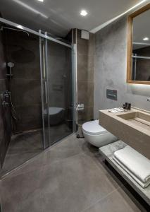 a bathroom with a shower and a toilet and a sink at Hotel Bosfora in Istanbul