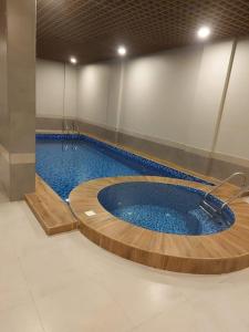 a large swimming pool with a large swimming pool at Voyage Residence in Riyadh