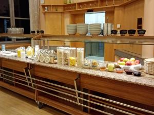 a kitchen with a counter with food on it at Spectrum Kirche Exerzitien-und Bildungshaus auf Mariahilf in Passau