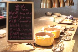 a menu for a restaurant with buckets of food at Jinhua Marriott Hotel in Jinhua