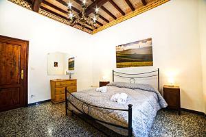 a bedroom with a bed with two towels on it at La casa di Giulina in Siena