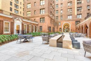 a courtyard with tables and chairs and buildings at Midtown East 1br w gym wd nr Grand Central NYC-1108 in New York