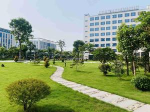 a walkway through a park in front of a building at Guangzhou Southern Airlines Pearl Airport Hotel in Guangzhou