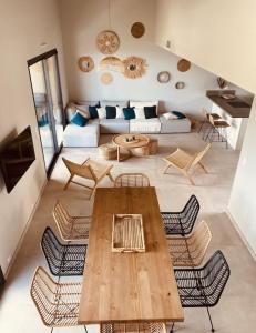 ein Wohnzimmer mit einem Holztisch und Stühlen in der Unterkunft RESIDENCE SAMBRO - Jacuzzi et piscine chauffée vue mer - 4 étoiles in Les Issambres