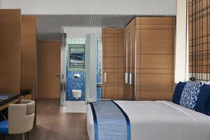 a bedroom with a large bed and a bathroom at JW Marriott Hotel Istanbul Marmara Sea in Istanbul