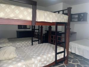 a couple of bunk beds in a room at Hotel/Hostal Casa Blanca in Aquismón
