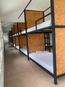 a row of bunk beds in a dorm room at Hotel/Hostal Casa Blanca in Aquismón +7 photos