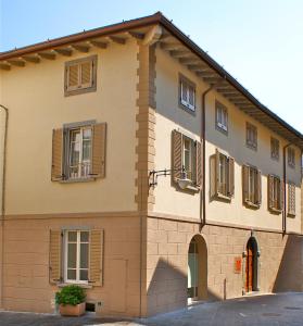 a building with windows and shutters on it at Albergo Diffuso Vulcano Village in Castro