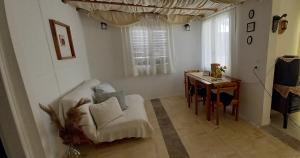 a living room with a chair and a table at Elizas house in Nea Makri