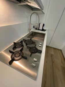 cocina blanca con fogones en Maison 140, en Lonato