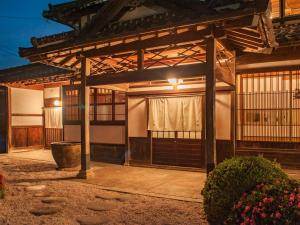 an entrance to a house with a wooden pergola at NIPPONIA Izumo Taisha Shrine Town in Izumo