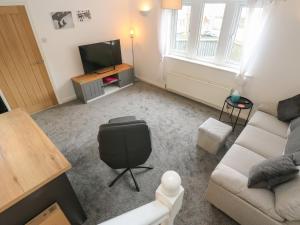 a living room with a couch and a television at Bowshaw in Holmfirth