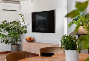 a living room with a tv and some plants at Strömstad/Stromstad close to the sea in Strömstad