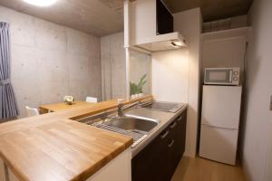 uma pequena cozinha com um lavatório e um frigorífico em Laffitte Okachimachi - Vacation STAY 8303 em Tóquio