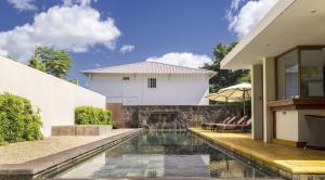 a house with a swimming pool in front of a house at Belle Haven Luxury Apartments in Mont Choisy