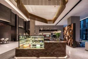 a lobby of a hotel with a bakery at UrCove by Hyatt Shanghai Lujiazui Expo Center in Shanghai