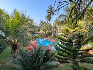 an overhead view of a resort with a pool and palm trees at Riverside Villa at Siolim in Siolim