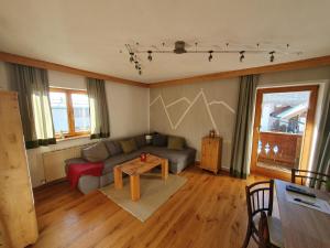 a living room with a couch and a table at Ferienwohnungen Riedl in Scharnitz