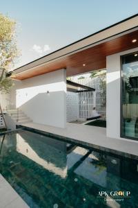a swimming pool in front of a house at H1 Pool Villa in Chiang Mai