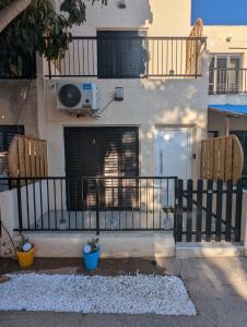 a fence in front of a building with a balcony at DreamIsland Maisonette Protaras in Paralimni