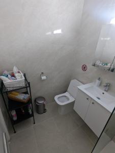 a bathroom with a white toilet and a sink at DreamIsland Maisonette Protaras in Paralimni