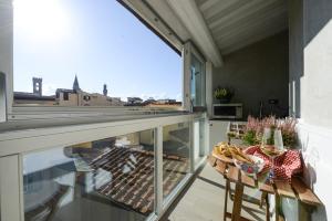 a balcony with a table and a view of the city at Duomo Suites Florence in Florence