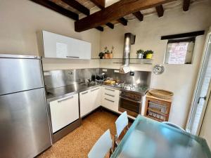 a kitchen with stainless steel appliances in a room at Borgo Storico Il Casetto in Sasso Marconi