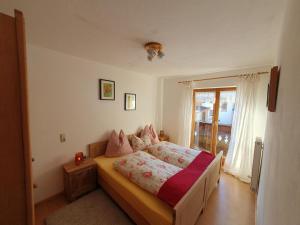 a bedroom with a bed and a window at Ferienwohnungen Riedl in Scharnitz