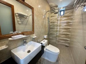 a bathroom with a sink and a toilet and a shower at The Land Hotel & Apartment in Vung Tau +44 photos