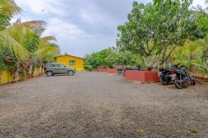 a group of motorcycles parked in a parking lot at Natures Dreamland Holiday Homes, Igatpuri in Igatpuri