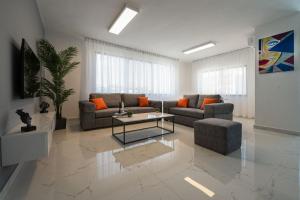 a living room with a couch and a table at Al Kawther Hotel Apartments in Amman