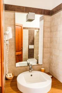a bathroom with a sink and a mirror at Agriturismo biologico Bulichella in Suvereto