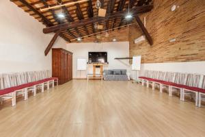 a large room with chairs and a projection screen at Masia Notari Casabona in Vilanova i la Geltrú