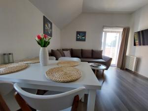 a living room with a white table and a couch at Rezidence GreenHill ⃰ ⃰ ⃰ in Kraslice