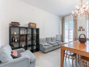 a living room with couches and a dining room at Flaminia Bright & Roomy Apartment in Pesaro