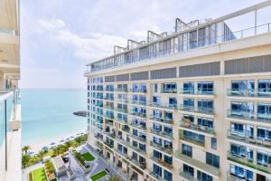 a building with a view of the ocean at Luxury 1BR Beachfront Apartment Marjan Island in Ras al Khaimah