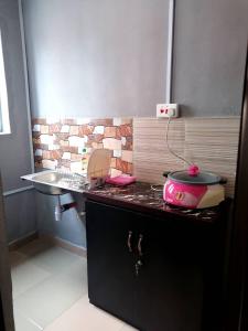 a kitchen with a counter with a sink and a stove at Pentagon Hotel and Suites in Umueme