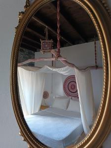 espejo con cama en un dormitorio en Avó da Rosa 3 en Povoação