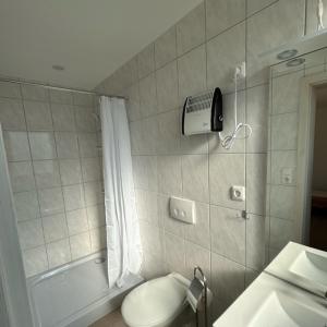 uma casa de banho com um WC, um chuveiro e um lavatório. em Ferienpark Buntspecht Apartment B em Pruchten