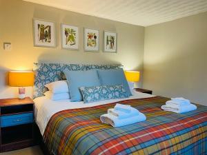 a bedroom with a bed with towels on it at The Cnoc Hotel in Beauly