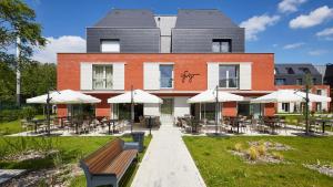 a building with tables and chairs in front of it at Le Domaine des Diamants Blancs in Croix