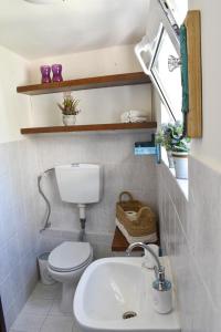 a small bathroom with a toilet and a sink at Selena Guest House in Krásion