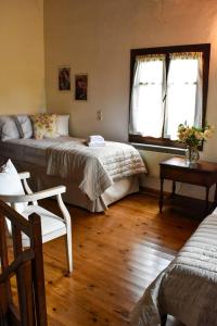 a bedroom with two beds and a couch and a table at Selena Guest House in Krásion