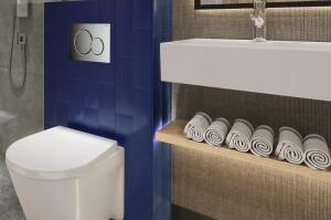 a bathroom with a toilet and a sink and a toilet paper holder at Erzurumlu Hotel in Kilyos